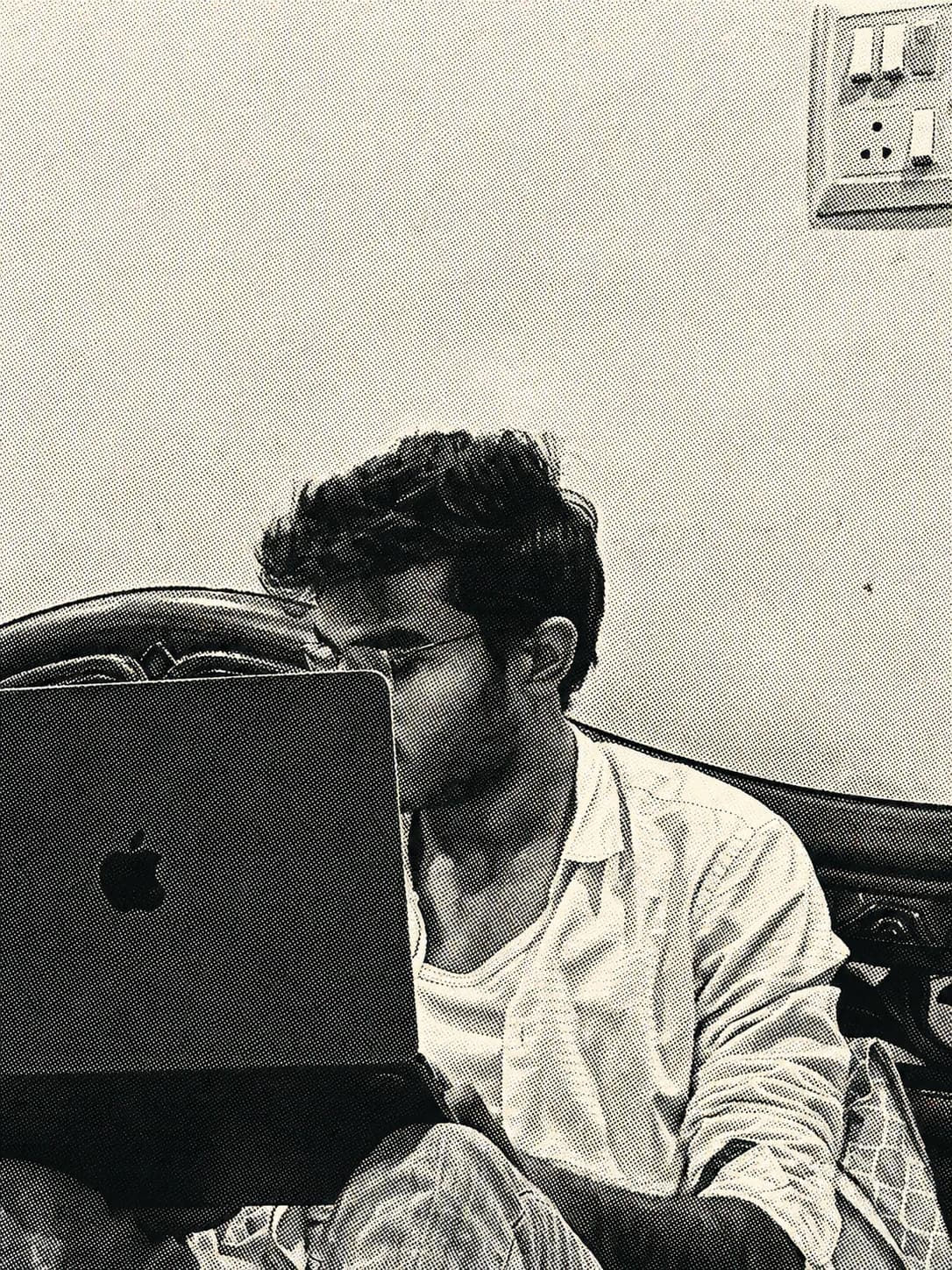 Jay working on a laptop